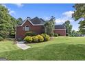 Brick house side view with landscaping and walkway at 65 Northwood Springs Dr, Oxford, GA 30054