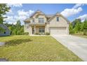 Two story home with a light brown brick exterior and a three car garage at 3201 Camden Ct, South Fulton, GA 30349