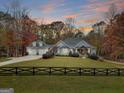 Gray two-story house with three car garage and a large front yard at 1080 Gaithers Rd, Mansfield, GA 30055