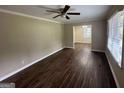 Living room with dark hardwood floors and ceiling fan at 2311 Amber Way, Decatur, GA 30032