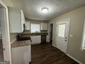 Galley kitchen with granite counters and white cabinets at 2311 Amber Way, Decatur, GA 30032