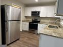 Modern kitchen with granite countertops and stainless steel appliances at 3188 Convair Ln, Decatur, GA 30032
