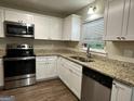 Modern kitchen with granite countertops and stainless steel appliances at 3188 Convair Ln, Decatur, GA 30032