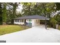 Updated ranch home with white exterior, green door and carport at 623 Montevista Sw St, Atlanta, GA 30310