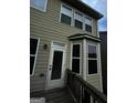 Home's back elevation, showcasing a deck and multiple windows at 844 Venture Sw Way, Atlanta, GA 30331