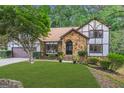 House exterior with stone facade and lush landscaping at 3142 Brooks Dr, Snellville, GA 30078