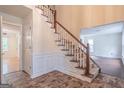 Open staircase with wooden railing and tile flooring at 3142 Brooks Dr, Snellville, GA 30078