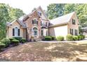 House exterior, two-story, stone and stucco, landscaping at 235 Ashley Forest Dr, Fayetteville, GA 30214