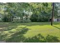 Large grassy backyard with tall ornamental grasses at 27 Smith St, Locust Grove, GA 30248