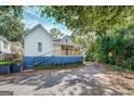 Side view of charming house with a porch and new paint at 2 Poplar St, Porterdale, GA 30070