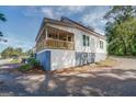 Rear view of charming house with a porch and new paint at 2 Poplar St, Porterdale, GA 30070