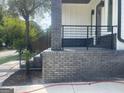 Modern home with a dark brick staircase and black railing at 3419 Hamilton Ave, Hapeville, GA 30354