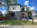 Modern two-story home with gray brick and white siding at 3419 Hamilton Ave, Hapeville, GA 30354