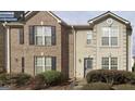 Two story townhome with brick and neutral color exterior at 4403 Pinscher St, Union City, GA 30291