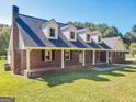 Brick ranch house with dormer windows and a covered front porch at 550 Davis Rd, Fayetteville, GA 30215