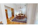 Bright dining room features hardwood floors, chandelier, and ample natural light at 1461 Hada Ln, Lawrenceville, GA 30043