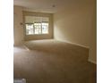 Spacious living room with large window and carpet at 2290 Nicole Dr, Hampton, GA 30228