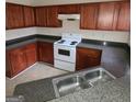 Kitchen with dark wood cabinets and granite countertops at 2290 Nicole Dr, Hampton, GA 30228