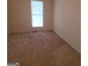 Simple bedroom with carpeted floor and a window at 2103 Grove Way, Hampton, GA 30228