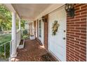 Inviting front porch with brick facade, columns, and terracotta tile floor at 4850 Lehigh Dr, Douglasville, GA 30135