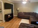 Spacious living room featuring a large sectional sofa and hardwood floors at 4850 Lehigh Dr, Douglasville, GA 30135