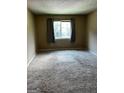 Spacious bedroom with neutral carpeting and large window at 1505 Camelot Dr, College Park, GA 30349