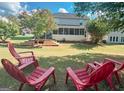 Relaxing backyard with a deck and red chairs at 2206 Sugar Maple Nw Ct, Acworth, GA 30101