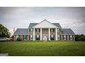 Two-story brick home with white columns and green shutters at 1530 Highway 11, Mansfield, GA 30055