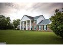 Brick house with white columns, green shutters, and a large lawn at 1530 Highway 11, Mansfield, GA 30055