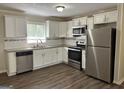 Modern kitchen with white cabinets and stainless steel appliances at 1863 Rollingwood Se Dr, Atlanta, GA 30316