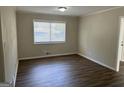 Bright living room featuring wood-look floors and a large window at 1863 Rollingwood Se Dr, Atlanta, GA 30316