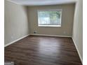 Simple bedroom with wood flooring and window at 1863 Rollingwood Se Dr, Atlanta, GA 30316
