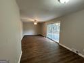 Spacious living area with dark hardwood floors and sliding glass doors at 2360 Green Forrest Dr, Decatur, GA 30032