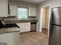 Updated kitchen with granite countertops and stainless steel dishwasher at 2360 Green Forrest Dr, Decatur, GA 30032