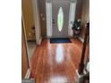 Hardwood floors and a charming entry door with glass accents at 1158 Folkstone Dr, Mcdonough, GA 30253