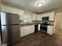 Modern kitchen with white cabinets, granite countertops, and stainless steel appliances at 2241 Sharon Way, Decatur, GA 30032