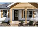 Front view of a charming house with a yellow accent and wood trim at 2029 Detroit Nw Ave, Atlanta, GA 30314