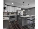 Modern kitchen with gray cabinets, white countertops, and a large island at 2029 Detroit Nw Ave, Atlanta, GA 30314