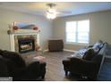 Living room with fireplace and hardwood floors at 110 Gwenellen Dr, Locust Grove, GA 30248