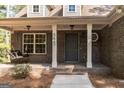 Front porch with a swing and brick columns at 5447 Centry Dr, Villa Rica, GA 30180