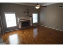 Spacious living room with hardwood floors and a brick fireplace at 50 Lydia Ct, Covington, GA 30016