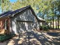 Attached gray garage with a driveway in front of it at 2323 Runnymede Ct, Jonesboro, GA 30236