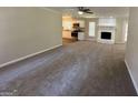 Spacious living room with gray carpeting, a stone fireplace, and an open floor plan at 3869 Rosedale Ln, Douglasville, GA 30135