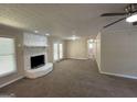 Spacious living room with a stone fireplace and neutral carpeting at 3869 Rosedale Ln, Douglasville, GA 30135