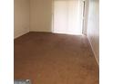 Spacious living room with wall-to-wall carpeting and a sliding glass door at 5914 Sutcliff Sq, Lithonia, GA 30058