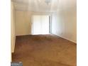 Bright living room with carpeted floors and sliding glass doors at 5914 Sutcliff Sq, Lithonia, GA 30058