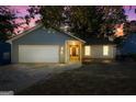 Gray house exterior at dusk, showcasing curb appeal at 8491 Cedar Creek Rdg, Riverdale, GA 30274