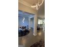 Elegant dining area with modern light fixture and seating for six at 938 Mulberry Fields Cv, Auburn, GA 30011