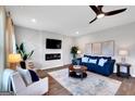 Bright living room with blue sofa, fireplace, and large windows at 7216 Tolar Rd # 9, South Fulton, GA 30213