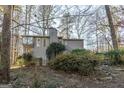 Two-story house with gray siding and wooded setting at 5260 Island Dr, Stone Mountain, GA 30087